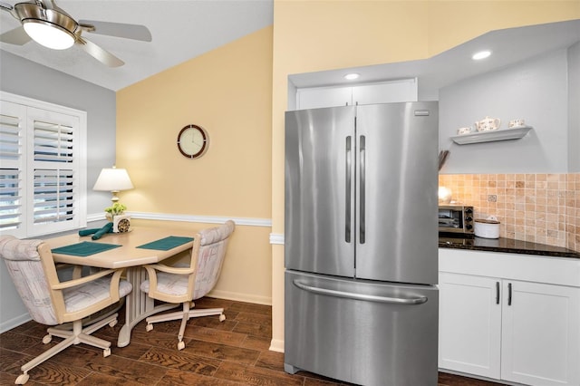 kitchen featuring freestanding refrigerator, a ceiling fan, white cabinets, and dark wood finished floors