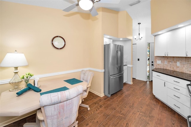 kitchen featuring freestanding refrigerator, dark countertops, high vaulted ceiling, a ceiling fan, and backsplash