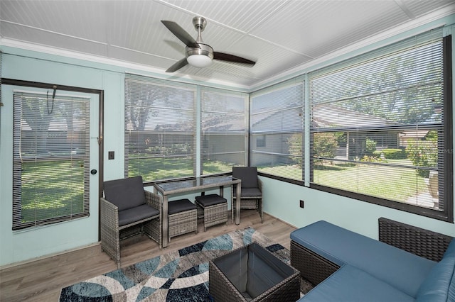 sunroom with a ceiling fan and a wealth of natural light