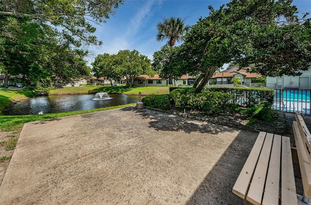exterior space with fence and a water view