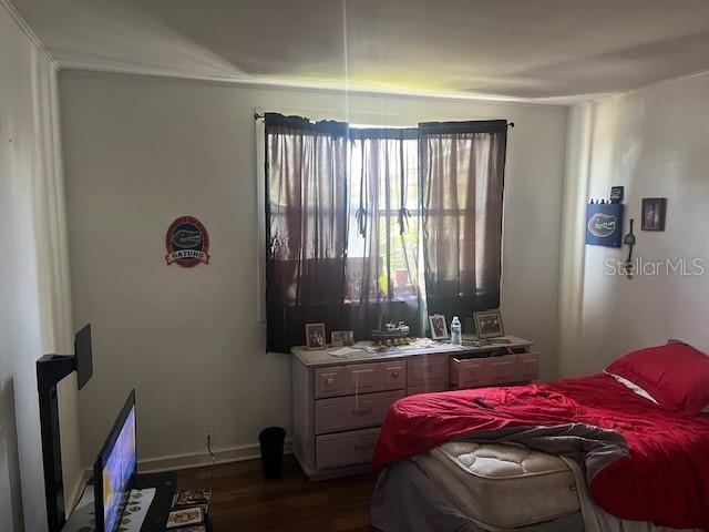 bedroom with dark wood-style floors and baseboards