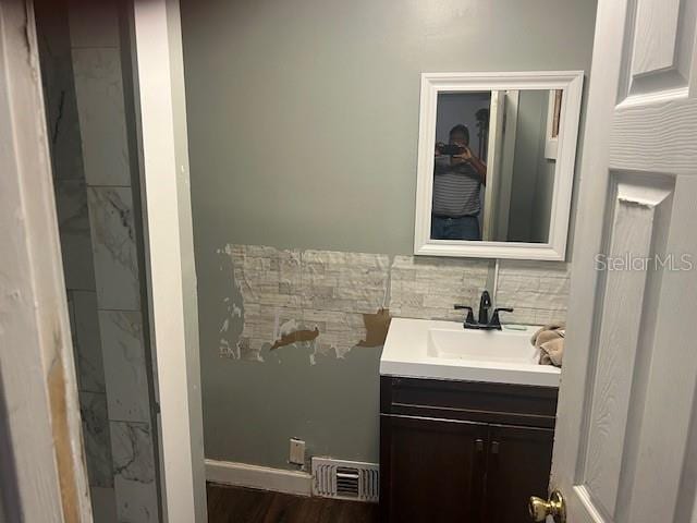 bathroom with visible vents, wood finished floors, and vanity