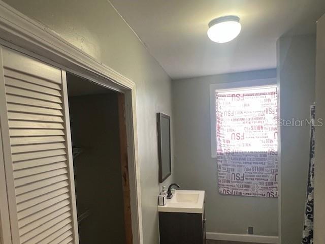 bathroom with vanity and baseboards