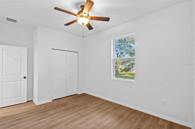 7603 Rhode Island Dr, Tampa, FL 33619 - unfurnished bedroom with baseboards, visible vents, light wood-type flooring, and a closet