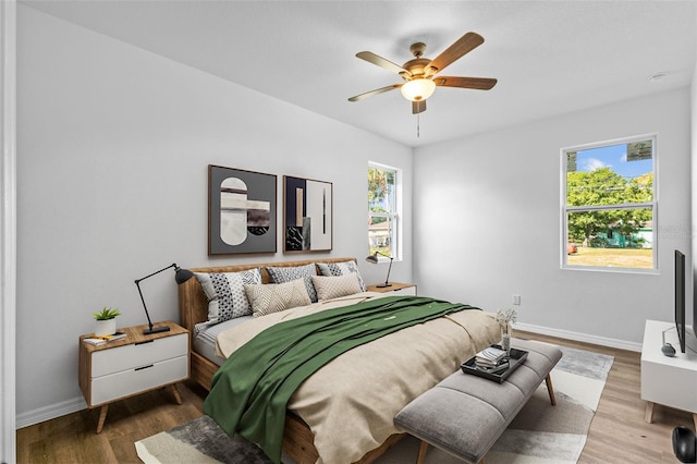 7603 Rhode Island Dr, Tampa, FL 33619 - bedroom featuring multiple windows, wood finished floors, and baseboards