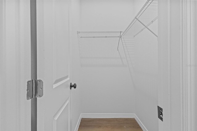 7603 Rhode Island Dr, Tampa, FL 33619 - walk in closet featuring dark wood-type flooring