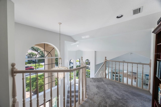 4815 Queen Palm Ter NE, Saint Petersburg, FL 33703 - corridor featuring lofted ceiling, an upstairs landing, carpet flooring, and a chandelier