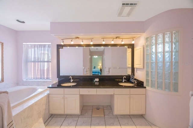4815 Queen Palm Ter NE, Saint Petersburg, FL 33703 - bathroom with double vanity and a bath