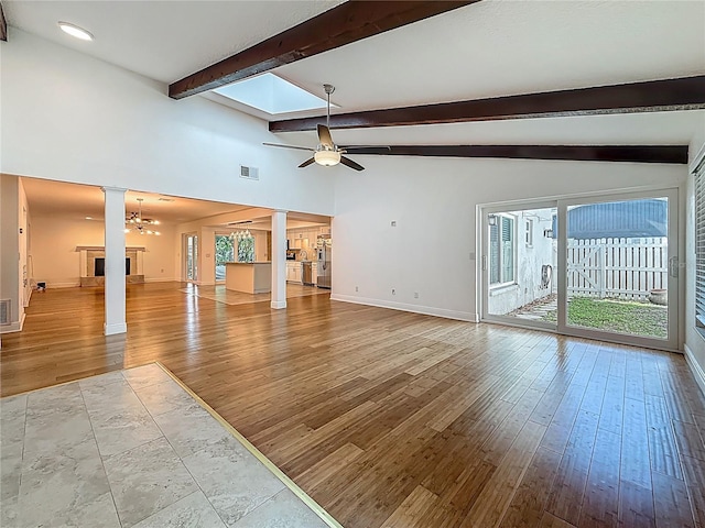 13891 Feather Sound Dr, Clearwater, FL 33762 - unfurnished living room with ornate columns, ceiling fan, and wood finished floors