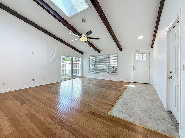 13891 Feather Sound Dr, Clearwater, FL 33762 - unfurnished living room featuring a skylight, a ceiling fan, and wood finished floors
