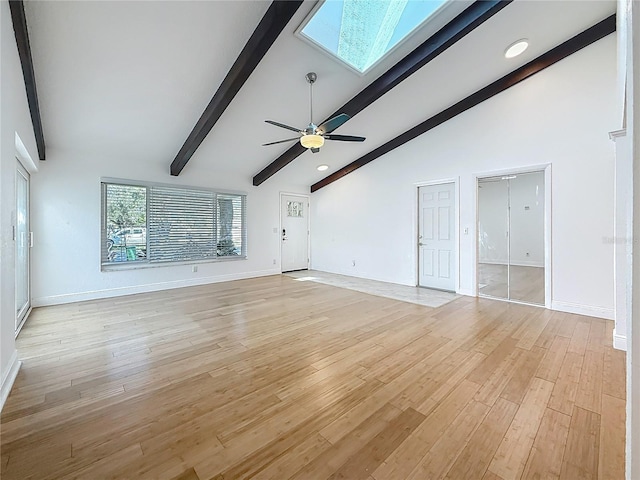 13891 Feather Sound Dr, Clearwater, FL 33762 - unfurnished living room featuring a skylight, light wood-style floors, a ceiling fan, and recessed lighting