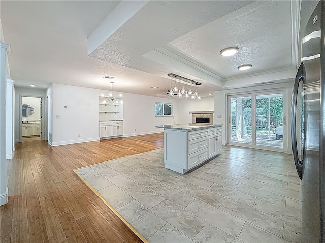 13891 Feather Sound Dr, Clearwater, FL 33762 - kitchen with freestanding refrigerator, a tray ceiling, a chandelier, a textured ceiling, and open floor plan