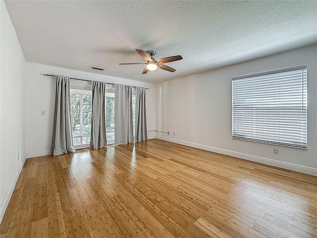 13891 Feather Sound Dr, Clearwater, FL 33762 - empty room with ceiling fan, light wood-style flooring, and a textured ceiling