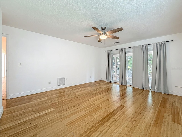 13891 Feather Sound Dr, Clearwater, FL 33762 - empty room with light wood-type flooring, a ceiling fan, and a textured ceiling