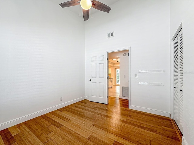 13891 Feather Sound Dr, Clearwater, FL 33762 - unfurnished bedroom featuring light wood-type flooring, a closet, ceiling fan, and a high ceiling