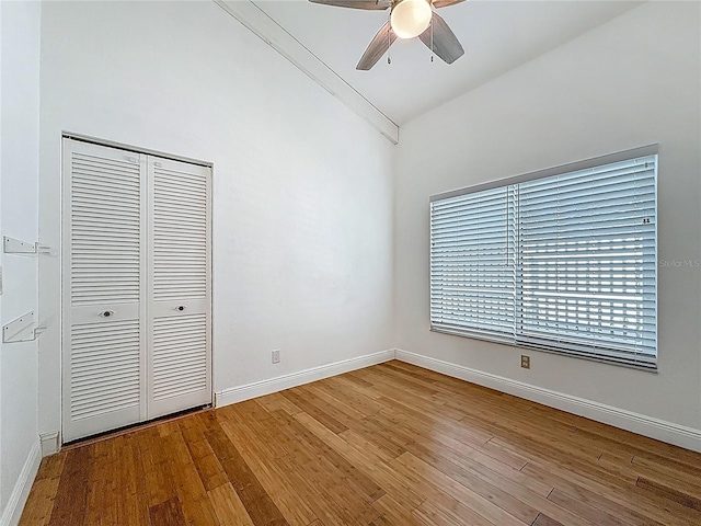 13891 Feather Sound Dr, Clearwater, FL 33762 - unfurnished bedroom featuring vaulted ceiling, wood finished floors, a closet, and ceiling fan