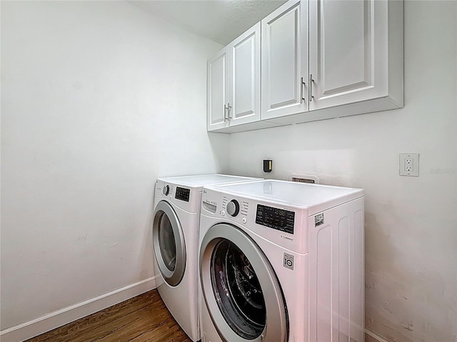 13891 Feather Sound Dr, Clearwater, FL 33762 - laundry area featuring cabinet space, washing machine and clothes dryer, and wood finished floors