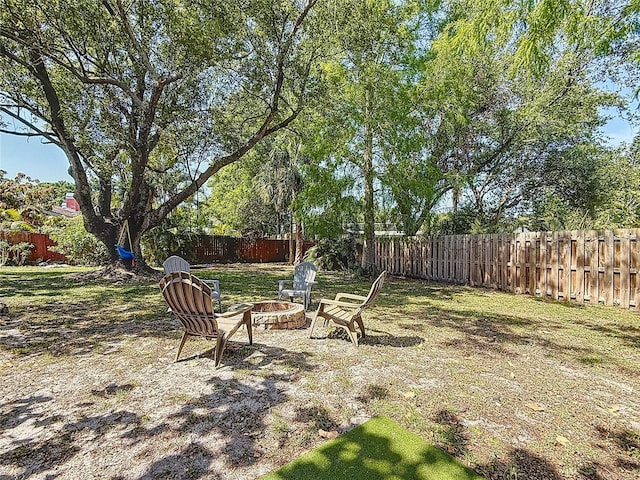 13891 Feather Sound Dr, Clearwater, FL 33762 - fenced backyard with a fire pit
