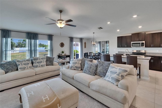 13506 Wild Ginger St, Riverview, FL 33579 - living area featuring recessed lighting, a ceiling fan, light tile patterned flooring, and a chandelier