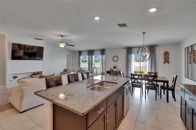 13506 Wild Ginger St, Riverview, FL 33579 - kitchen featuring dishwasher, light stone counters, decorative light fixtures, a center island with sink, and open floor plan
