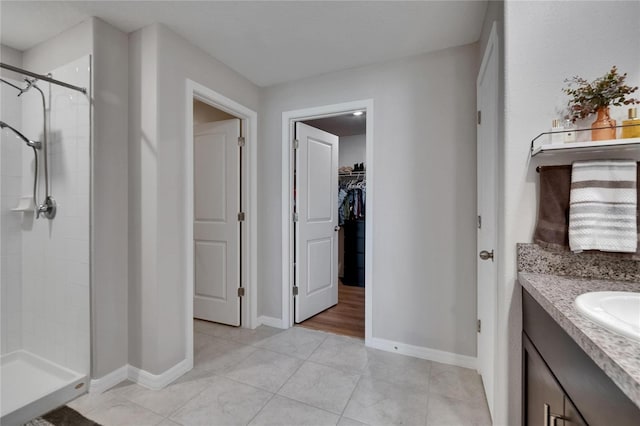 13506 Wild Ginger St, Riverview, FL 33579 - full bath featuring a stall shower, vanity, a walk in closet, and tile patterned flooring
