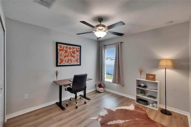 13506 Wild Ginger St, Riverview, FL 33579 - office with wood finished floors, ceiling fan, and a textured ceiling