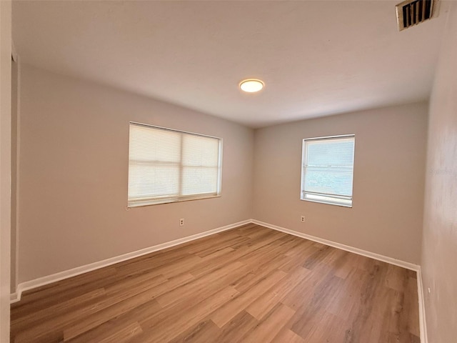 1505 Piedmont Dr, Deltona, FL 32725 - unfurnished room featuring healthy amount of natural light, light wood finished floors, and baseboards