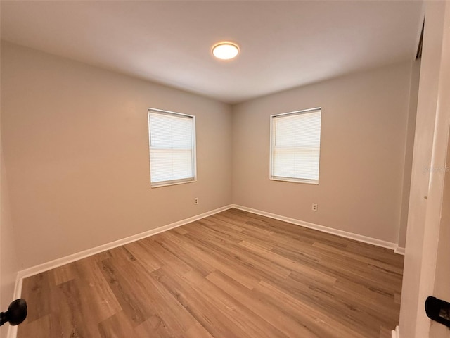 1505 Piedmont Dr, Deltona, FL 32725 - empty room with wood finished floors and baseboards