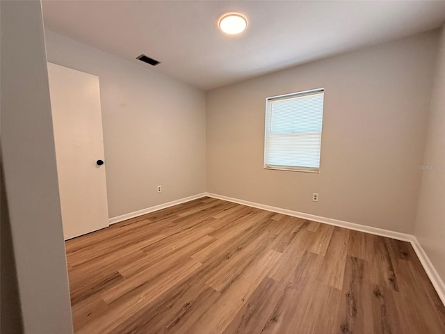 1505 Piedmont Dr, Deltona, FL 32725 - spare room with wood finished floors and baseboards