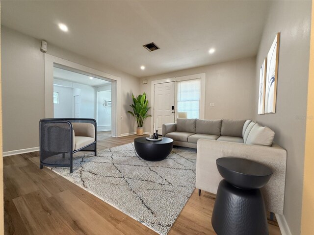 1505 Piedmont Dr, Deltona, FL 32725 - living area with wood finished floors, recessed lighting, and baseboards