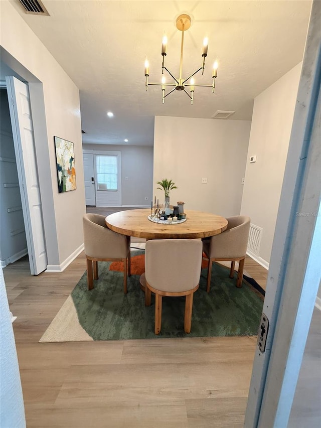 1505 Piedmont Dr, Deltona, FL 32725 - dining area featuring a chandelier, wood finished floors, baseboards, and recessed lighting