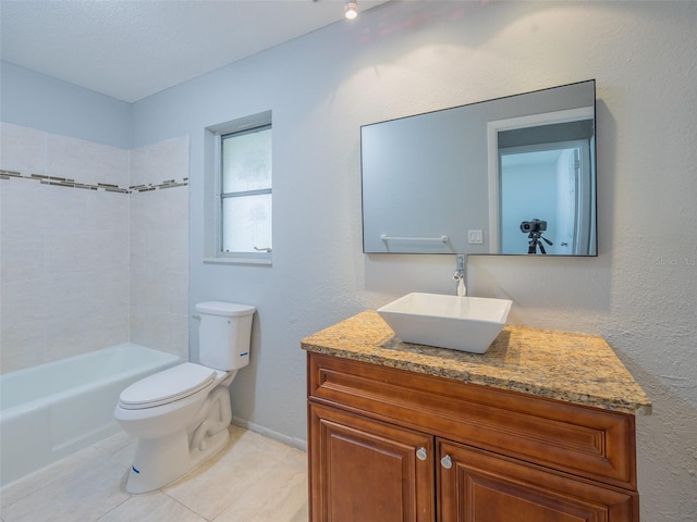 full bathroom featuring vanity, a textured wall, baseboards, toilet, and tile patterned flooring
