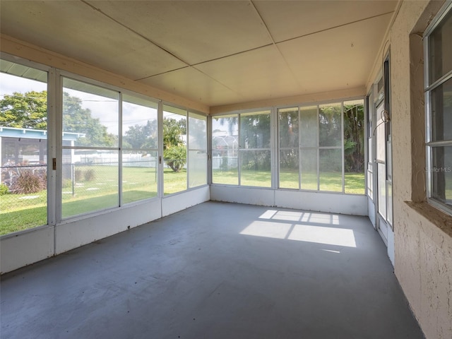 unfurnished sunroom with a wealth of natural light and a water view