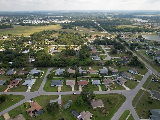 drone / aerial view featuring a water view and a residential view