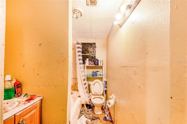 bathroom featuring toilet, vanity, and shower / bathtub combination with curtain