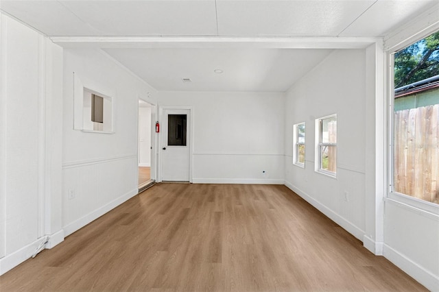 empty room with light wood finished floors and baseboards