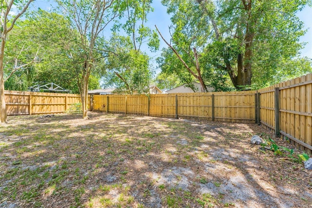 view of yard with a fenced backyard