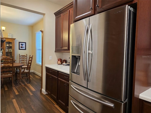 kitchen with light countertops, dark wood-style flooring, baseboards, and stainless steel fridge