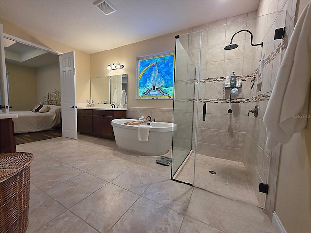 ensuite bathroom featuring visible vents, a tile shower, vanity, a soaking tub, and ensuite bath