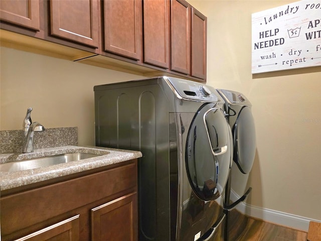 13525 Gorgona Isle Dr, Windermere, FL 34786 - laundry area featuring independent washer and dryer, cabinet space, baseboards, and wood finished floors