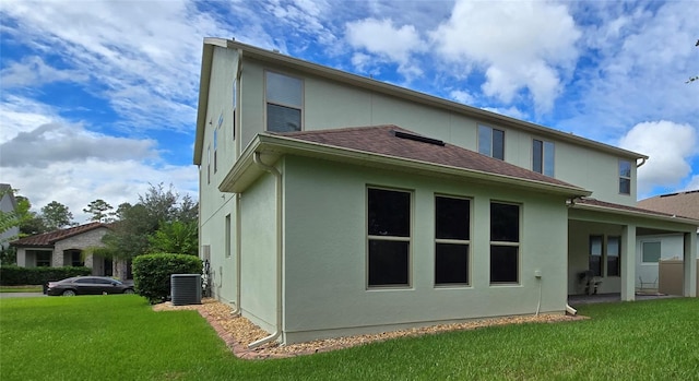 13525 Gorgona Isle Dr, Windermere, FL 34786 - back of property with stucco siding, central AC, a yard, and a shingled roof