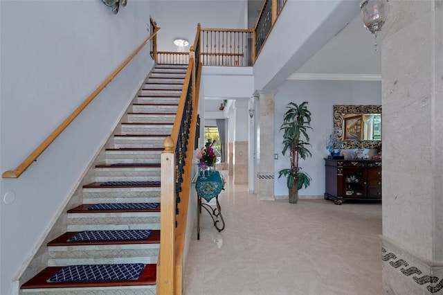 15630 N Himes Ave, Tampa, FL 33618 - stairway featuring a high ceiling, ornate columns, and crown molding