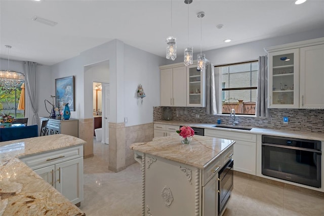 15630 N Himes Ave, Tampa, FL 33618 - kitchen featuring pendant lighting, a sink, black appliances, and a healthy amount of sunlight