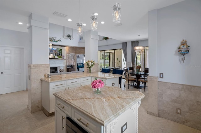 15630 N Himes Ave, Tampa, FL 33618 - kitchen featuring white cabinets, open floor plan, visible vents, and light tile patterned floors