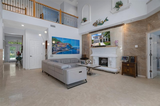 15630 N Himes Ave, Tampa, FL 33618 - living room featuring a high ceiling, a fireplace with raised hearth, and visible vents