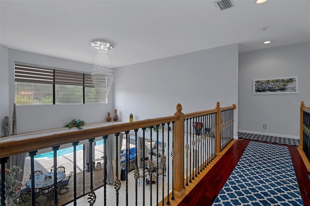 15630 N Himes Ave, Tampa, FL 33618 - hall featuring baseboards, visible vents, a wealth of natural light, and a notable chandelier