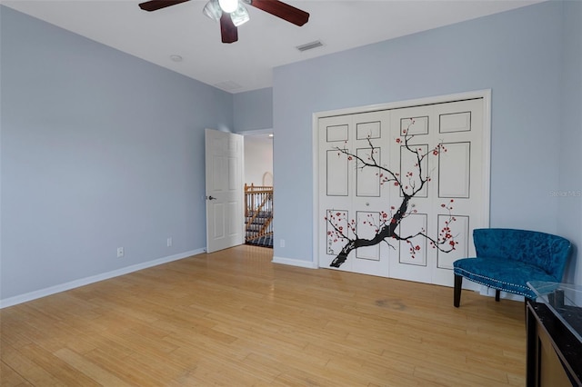 15630 N Himes Ave, Tampa, FL 33618 - living area featuring ceiling fan, an upstairs landing, visible vents, and light wood-style floors