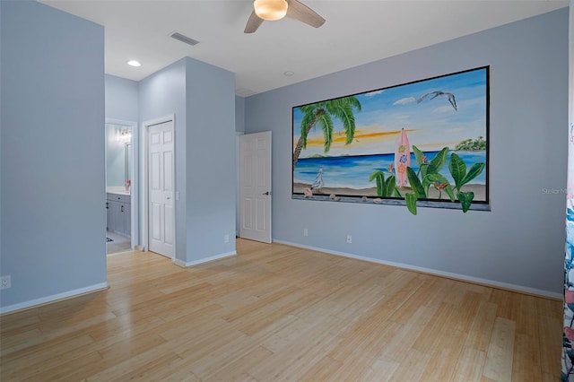 15630 N Himes Ave, Tampa, FL 33618 - unfurnished bedroom with wood finished floors, visible vents, baseboards, and ensuite bathroom