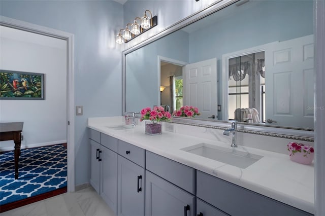 15630 N Himes Ave, Tampa, FL 33618 - bathroom with baseboards, marble finish floor, a sink, and double vanity