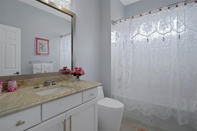 15630 N Himes Ave, Tampa, FL 33618 - full bath featuring shower / bath combo with shower curtain, vanity, marble finish floor, and toilet